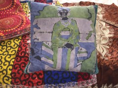 Sierra Leone woman batik pillow and embroidered clothes, July 2017