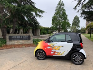 Katy Dickinson flaming 2017 SmartCar at Pacific School of Religion, Berkeley