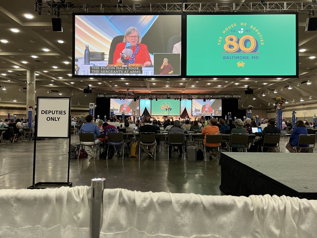 Rev. Gay Clark Jennings with pigeon mascot, General Convention, 11 July 2022