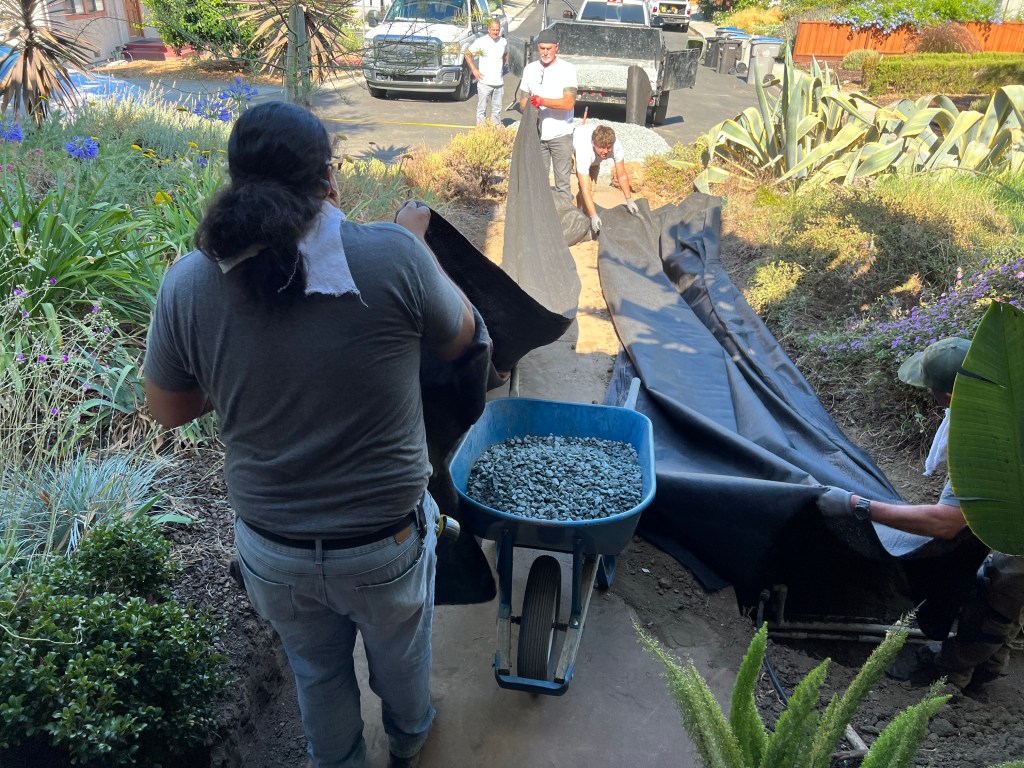 French drain lining and rock, July 2022