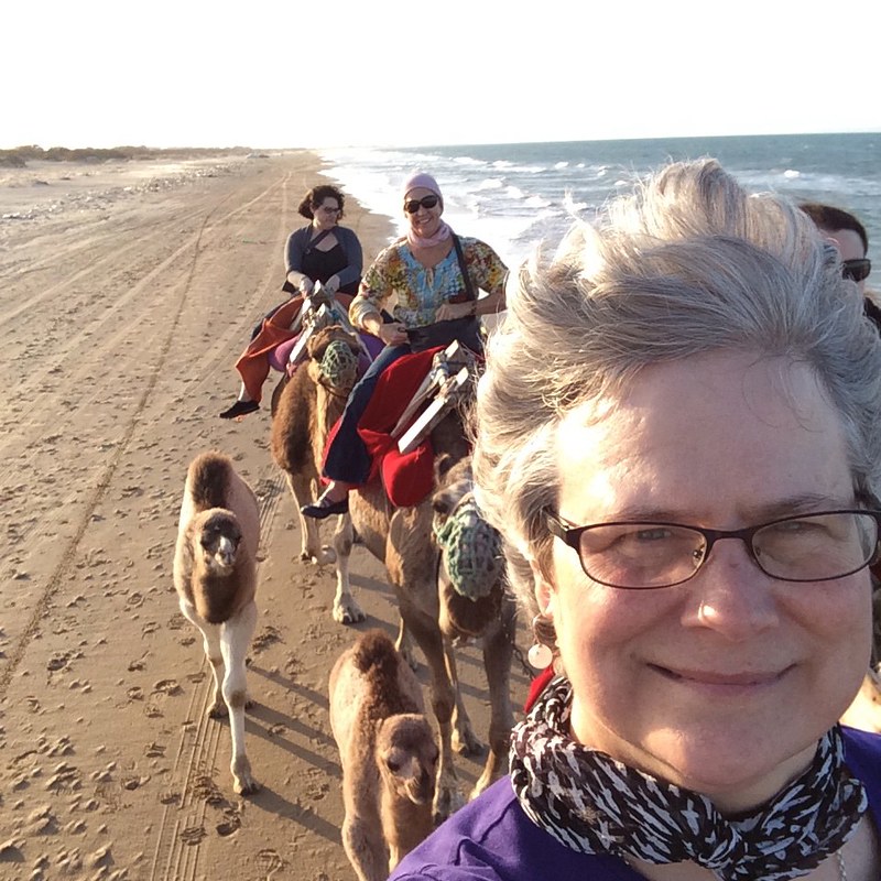 Katy Dickinson and TechWomen on beach camels, Tunisia 2015
